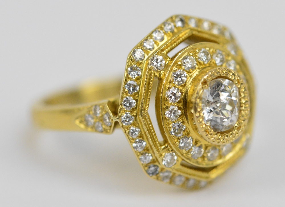 A contemporary 18ct yellow gold diamond set three tiered cluster ring,