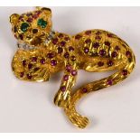 A 9ct yellow gold ruby diamond and emerald set brooch modelled as a leopard, width 4cm, approx 12g.