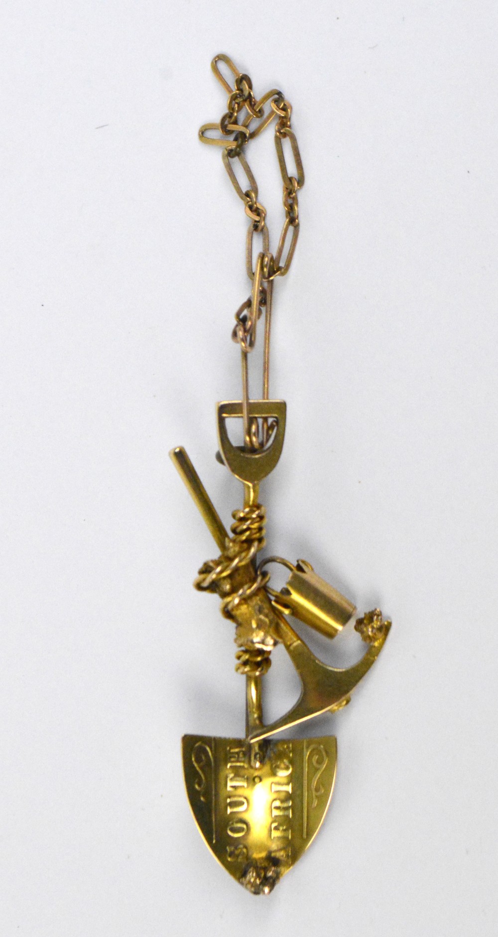 An 18ct yellow gold South African gold digger brooch modelled as a spade, pick and bucket,