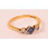An 18ct yellow gold ring set with a square sapphire flanked by two round cut diamonds, both 0.