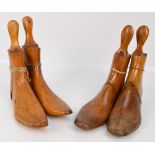 A pair of four part shoe lasts, marked 7 and 4, and a further pair of three part shoe lasts,