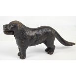 A cast iron nutcracker in the form of a standing dog, the cracker being operated by his tail,