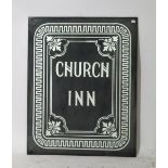 A grey and silver sign for "Church Inn", the image fixed to the reverse of a pane of glass,