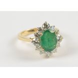 An 18ct yellow gold emerald and diamond cluster ring,