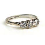 An 18ct white gold three stone diamond ring, the central stone approx 0.