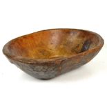 An 18th/19th century elm oval dairy bowl with an adzed decoration to the exterior and simple