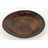 An 18th/19th century rustic walnut shallow bowl with twin dished panels to the centre and two bands