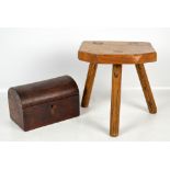 A 19th century rustic elm three legged milking stool and a Victorian walnut dome top casket