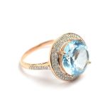 A 14ct rose gold topaz ring, approx 7ct, set with outer diamonds, ring size R.