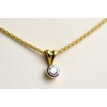 An 18ct yellow gold and platinum mounted single brilliant cut diamond pendant, approx 0.