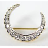 An 18ct diamond set crescent shaped brooch, length 2.7cm, hallmarked for Birmingham 1976.