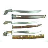 Three Malayan Golok, the first with 53cm heavy fullered blade, characteristic carved horn hilt,