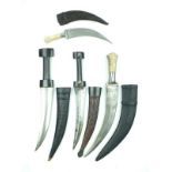 Four Jambiya, the first two having blades with raised medial ridges and horn hilts and contained