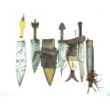 Four North African daggers or side arms, the first with 27.5cm leaf-shaped blade, ivory hilt with