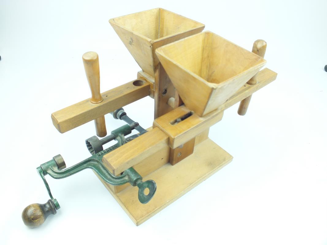 An unusual bench mounted wooden and iron shot dispenser reloading machine, the handmade box wood