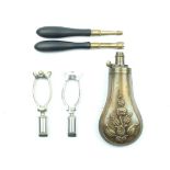 A small collection of accessories, to include an embossed copper powder flask decorated with