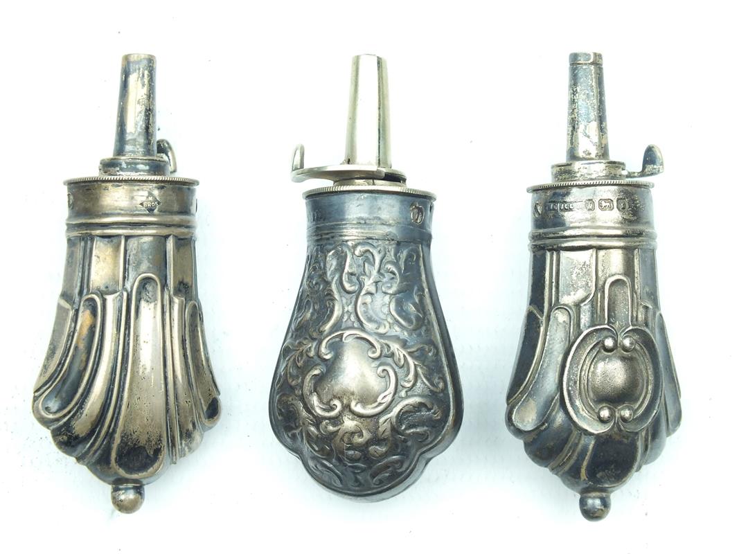 Two miniature hallmarked silver powder flasks, each embossed with geometric designs and a further