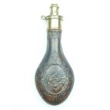 An embossed Horses Heads powder flask, the copper body decorated with three horses heads and