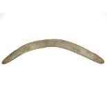 A stone carved boomerang, 74.5cm diameter body carved with a pair of Emu and a Kangaroo in a