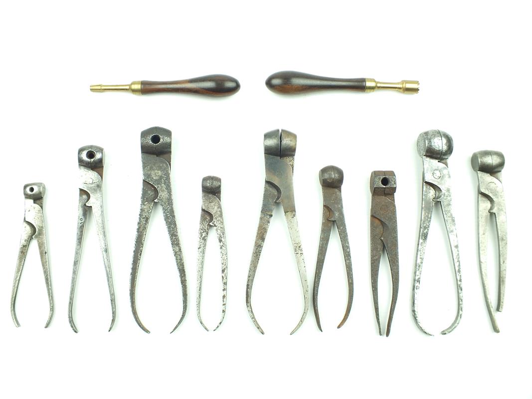 Nine various scissor bullet moulds, some marked with bore size together with two modern cleaning