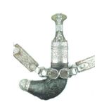 A white metal mounted Arab Jambiya, 18cm sharply curved blade with raised medial ridge,