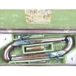 A cased pair of 25-bore flintlock duelling pistols by Bennett, 9.5 inch sighted octagonal,