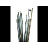 A small collection of loading and cleaning rods, variously with wooden and metal hafts and brass