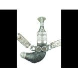 A white metal mounted Arab Jambiya, 18cm sharply curved blade with raised medial ridge,