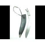 A white metal mounted Kukri, 33cm sharply curved blade with short double fullers to the back edge,