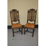 Pair of carved oak Jacobean style dining chairs (damaged)