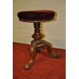 Victorian carved revolving piano stool on splayed triple support base