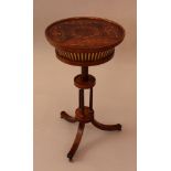 Small French Restauration needlework table, on three shaped legs with bronze wheels; three needle