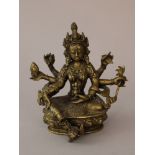 Indian goddness in sitting possition with six hands holding ritual objects, on oval lotus base;