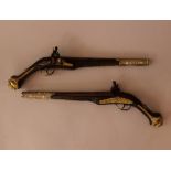 Pair of baroque rider pistols, with long barrel, stone lock system; the iron barrel and lock with