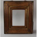 Wooden frame with wide borders, walnut with intensive bronze floral intarsias, stepped form with