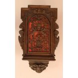 Flemish cupboard with one door and carved angels on the sides, top and bottom; geometric form; the