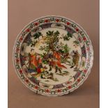 Chinese porcelain dish with scene of a general in landscape, surrounded by ornaments and