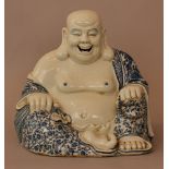 Chinese porcelain smiling Buddha, in sitting possition, with chain in his hand; painted in blue on