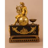 Empire clock with Hermes and the lyra on top, bronze mantel partly gilded and ebonised with round