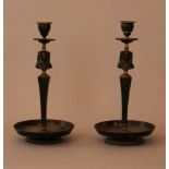 Pair of Egyptian classical style candlesticks, bronze cast with canted middle string and Egiptian