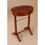 Small Directoire table in oval shape on two collumn feet, with four waved and carved legs; with