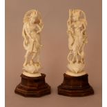 Pair of Indian ivory goddnesses finely carved on lotus bases, with music instruments and animals