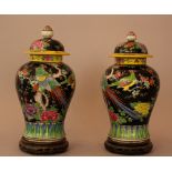 Pair of Chinese porcelain vases in Familie Noir manner, with multicoloured painted birds, flowers