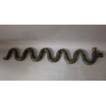 Pharmacy hanging sign in form of a snake, naturalistically carved and green, golden and red painted,