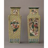 A pair of Chinese Cantonese porcelain vases, cilindrical form with shaped neck, with rich painted