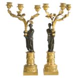 A pair of Directoire ormolu and patinated bronze three -light figural candelabra