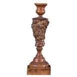 A pair of North European walnut candlesticks