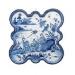 A blue and white shaped square plaque