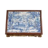 A North European red and gilt japanned and delft tile panel centre table