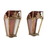 A pair of North European gilt metal and tôle peinte wall lanterns